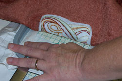 Removing the finished embroidered fabric from the Sticky machine embroidery stabilizer.