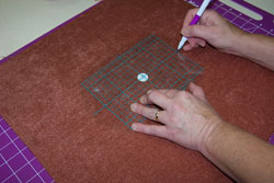 Marking the fabric in preparation to hoop it.